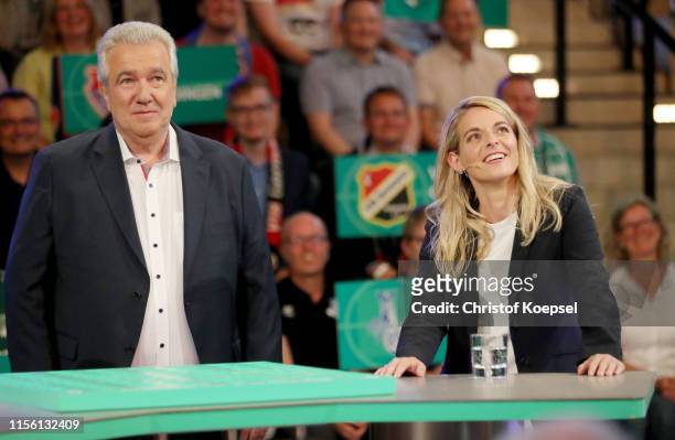 Peter Frymuth, head of DFB Cup Draw and vice-president of DFB and Nia Kuenzer, former player of Germany react during the DFB Cup 2019/20 First Round...