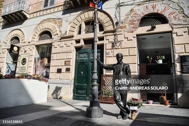 Picture taken on July 17, 2019 shows the statue of "Inspector Salvo Montalbano", a character created by Italian writer Andrea Camilleri, in the...