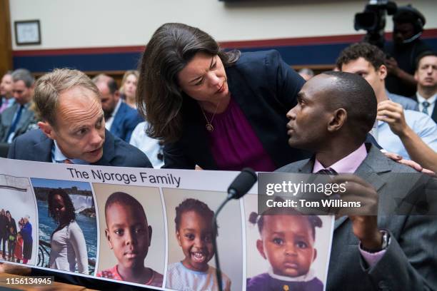 Rep. Angie Craig, D-Minn., talks with Paul Njoroge, right, and Michael Stumo, who lost families members in the crash of Ethiopian Airlines Flight...