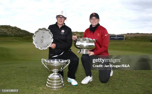 Emily Toy of England poses with the trophy and runner up Amelia Garvey of New Zealand following victory during the final match on day five of the R&A...