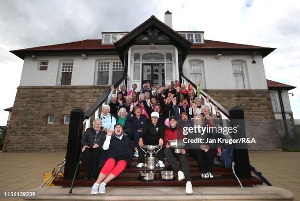 Emily Toy of England and runner up Amelia Garvey pose with members during the final match on day five of the R&A Womens Amateur Championship at Royal...