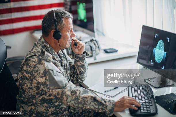 senior soldier with headphones working - national guard stock pictures, royalty-free photos & images