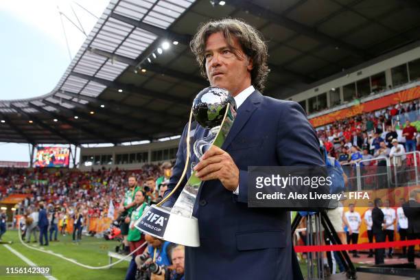 Former Portugal Footballer Fernando Couto walks out with the FIFA U-20 World Cup trophy after the 2019 FIFA U-20 World Cup Final between Ukraine and...
