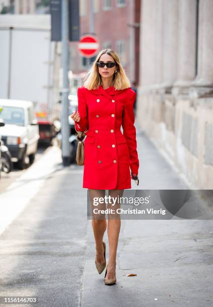 Candela Novembre is seen wearing red coat outside M1992 during the Milan Men's Fashion Week Spring/Summer 2020 on June 15, 2019 in Milan, Italy.