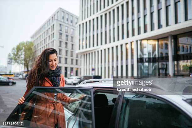 catching a ride share in berlin - entering stock pictures, royalty-free photos & images