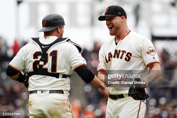 Will Smith of the San Francisco Giants celebrates with Stephen Vogt after beating the Milwaukee Brewers and getting the save at Oracle Park on June...