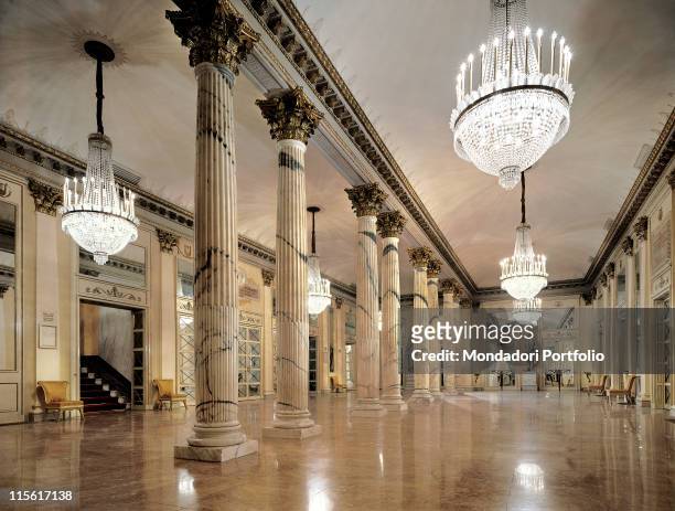 Italy; Lombardy; Milan; Teatro alla Scala. View foyer columns stairs marble floor mirrors chandelier capitals gold frame/cornice statue Giuseppe Verdi