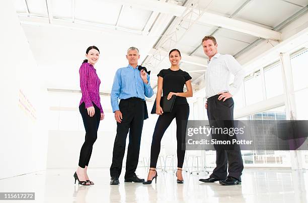 confident business team - group of businesspeople standing low angle view stock pictures, royalty-free photos & images