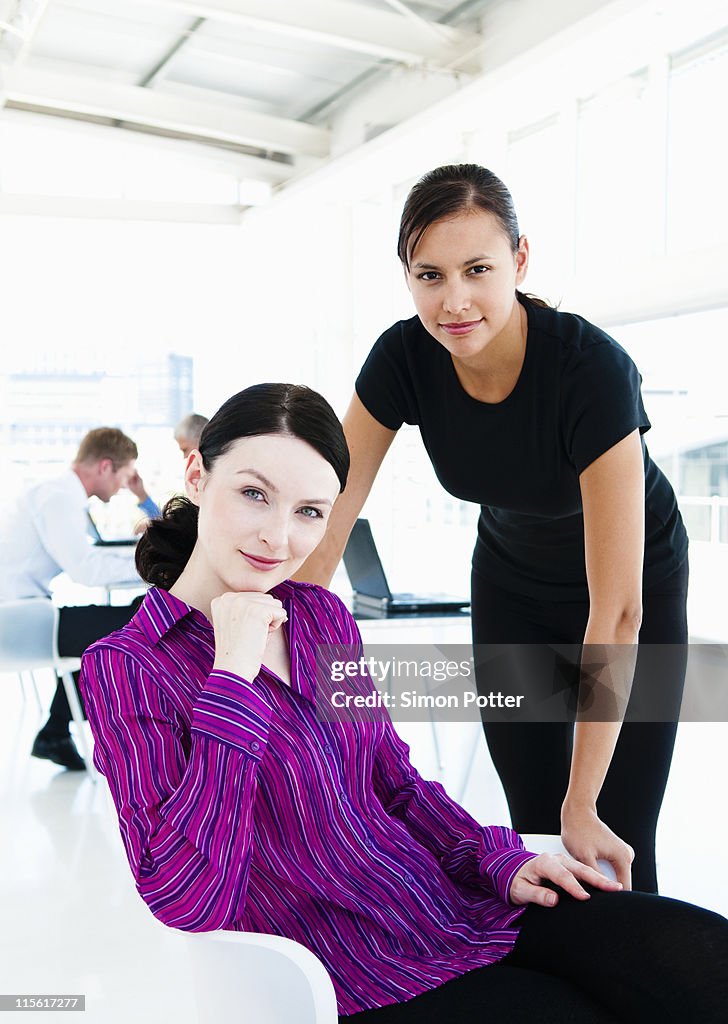 Two businesswomen with team