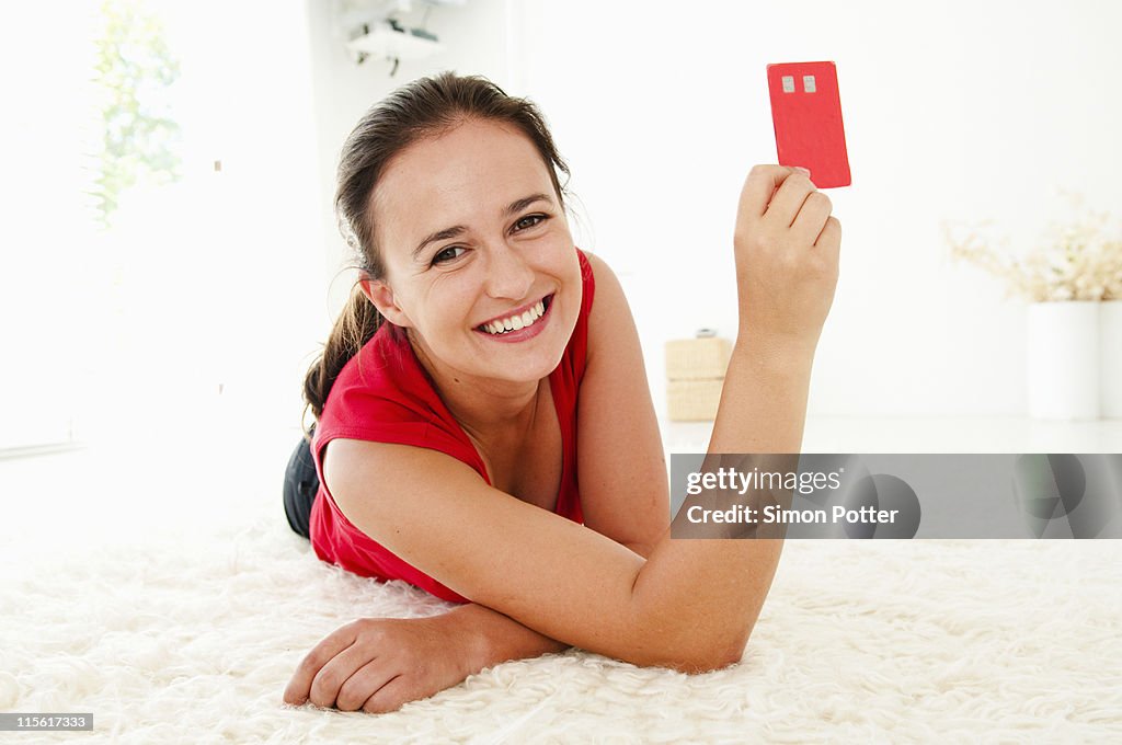 Woman holds up credit card