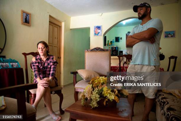 Alba Bencosme speaks next to her husband during an interview with AFP after her daughter died of Dengue fever in Santo Domingo on July 13, 2019. - An...