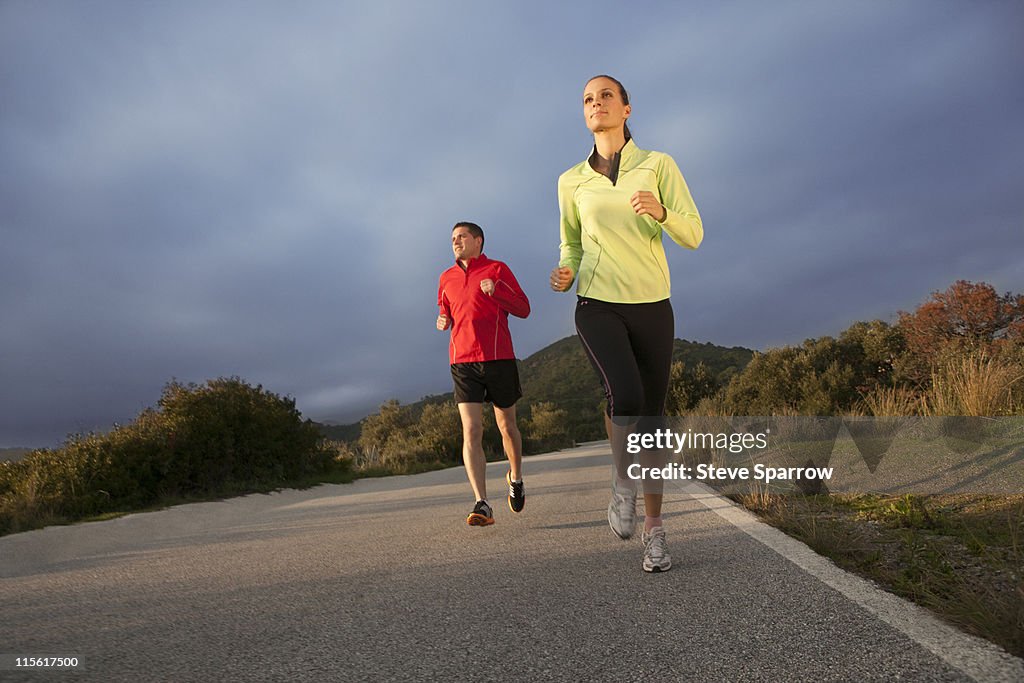 Young couple jogging in rural setting