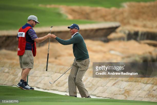 Matt Kuchar of the United States and his caddie, John Wood, fist pump on the 18th hole during the third round of the 2019 U.S. Open at Pebble Beach...