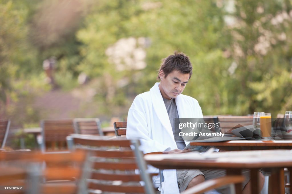 Man enjoying breakfast on outdoor patio