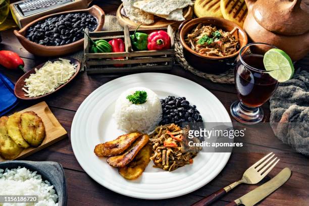 venezuelan traditional food, pabellon criollo with arepas, casabe and papelon with lemon drink - caracas stock pictures, royalty-free photos & images