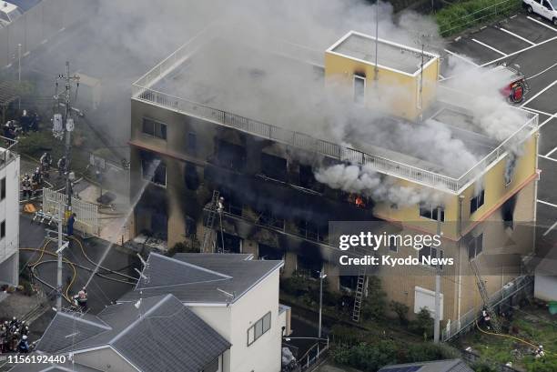 Photo taken July 18 from a Kyodo News helicopter shows the three-story studio of Kyoto Animation Co. In Kyoto after a man started a fire there. The...