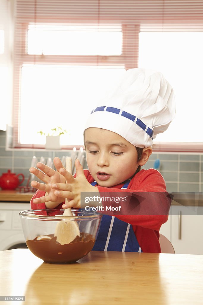 Young boy stirring bowl of chocolate