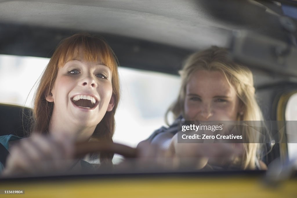 Women having fun driving a car