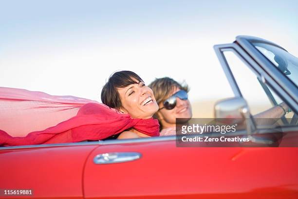 woman and man in a convertible - man driving sports car stock pictures, royalty-free photos & images