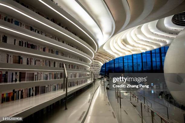 Light effects of Tianjin Binhai Cultural center Library at night. With a huge spherical multi-function hall and circle steps to the ceiling, Tianjin...