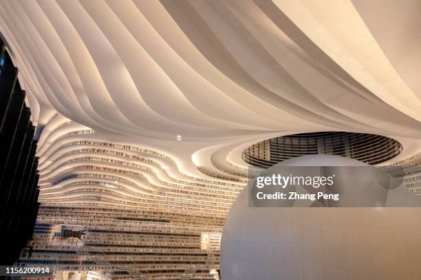 Light effects of Tianjin Binhai Cultural center Library at night. With a huge spherical multi-function hall and circle steps to the ceiling, Tianjin...