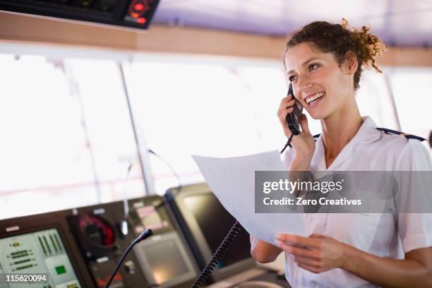 mate of a ship doing a phone call - boat captain stock pictures, royalty-free photos & images