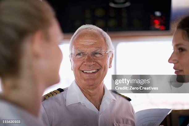 captain talking to mates - boat captain fotografías e imágenes de stock