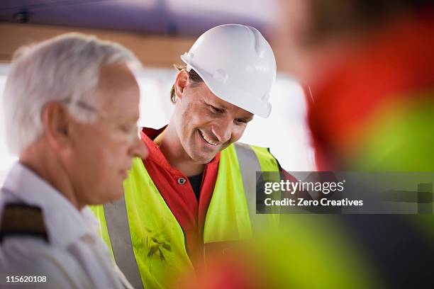 captain talking to workers - boat helm stock pictures, royalty-free photos & images