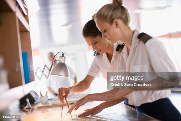 sailors setting the compasses - capitaine de bateau photos et images de collection