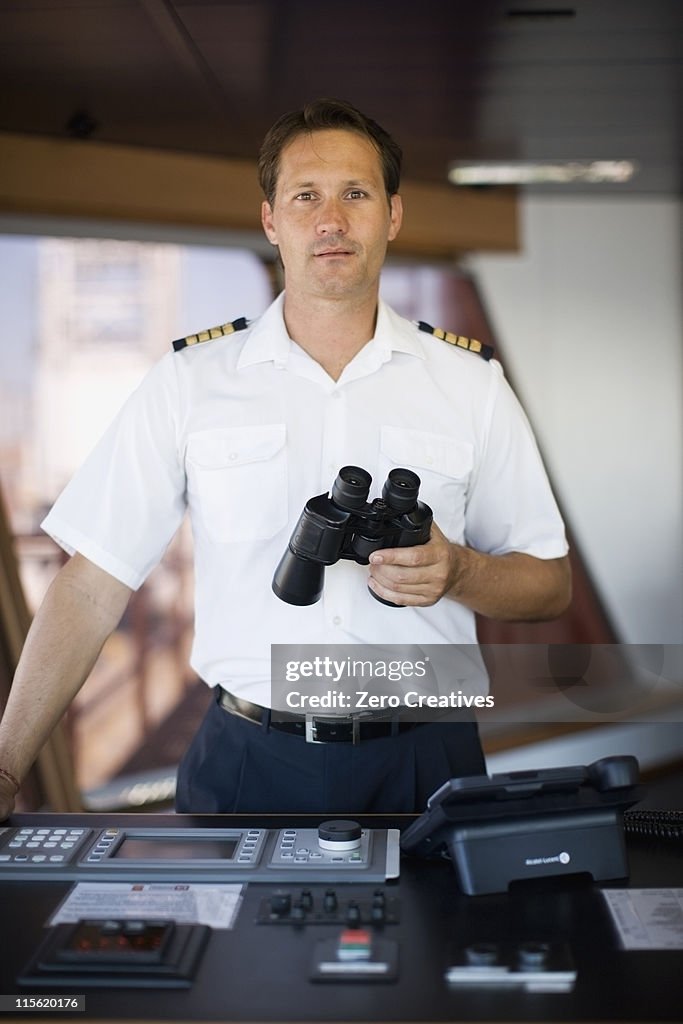 Captain holding binoculars in his hands