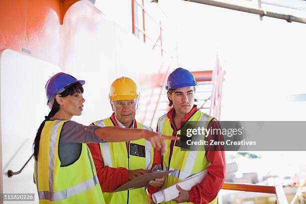 architects and builders at work - construction meeting helmet stock pictures, royalty-free photos & images