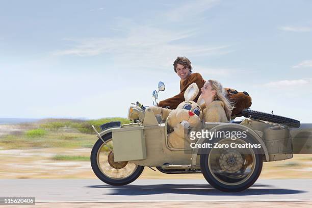 disguised couple on motorbike - moto humour photos et images de collection