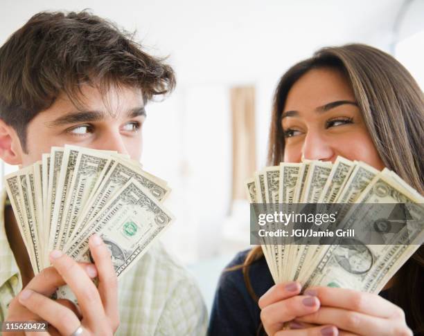 couple holding handfuls of money - dating show stock pictures, royalty-free photos & images