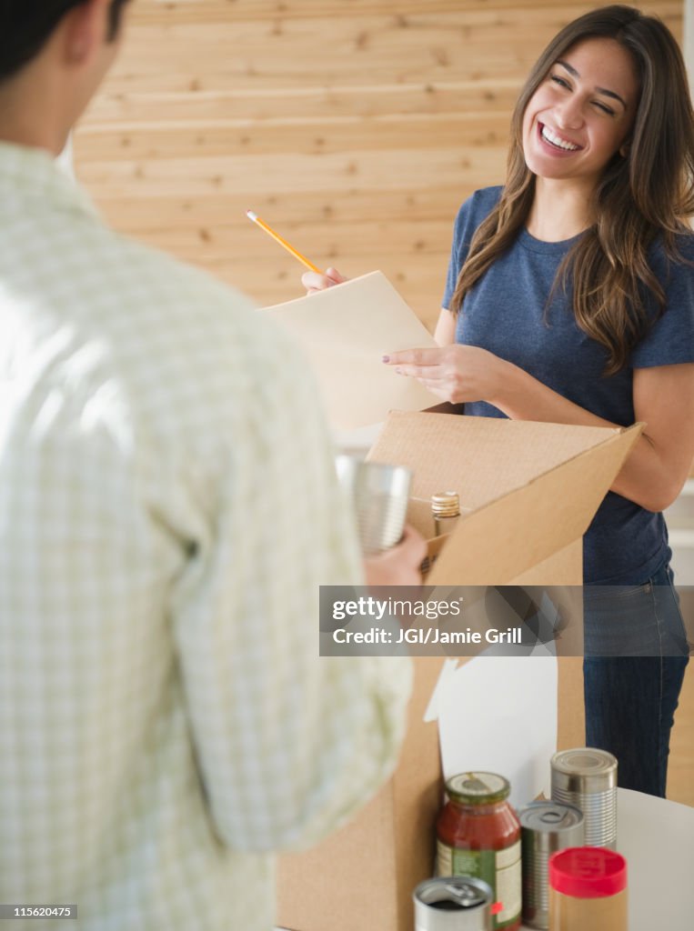 Couple packing boxes together