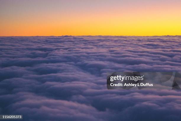 sunset above the clouds - clouds from aircraft point of view stock pictures, royalty-free photos & images