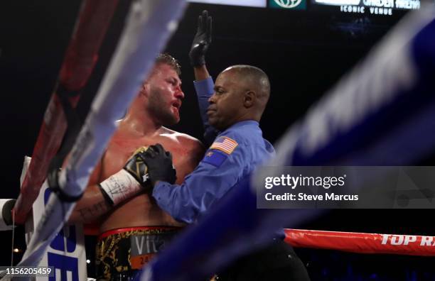 Referee Kenny Bayless moves in to protect Tom Schwarz and call off the fight in the second round during a heavyweight fight against Tyson Fury at MGM...