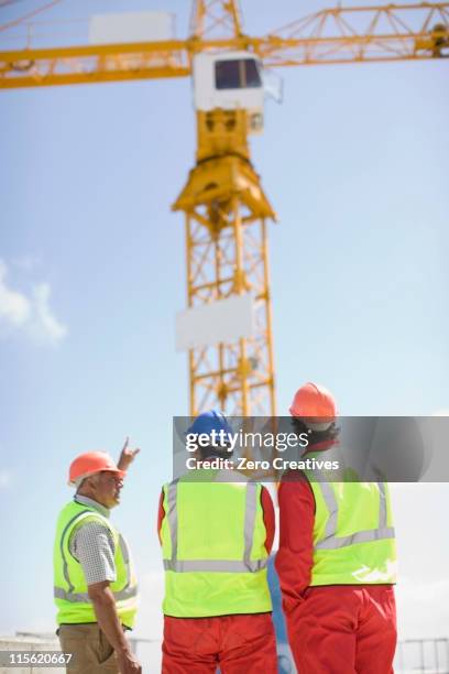 workers inspecting a building plot - group of people looking up side view stock pictures, royalty-free photos & images