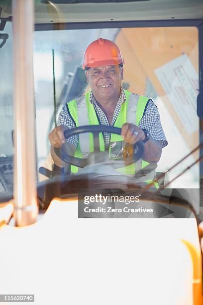 building worker driving a fork truck - forklift outside stock pictures, royalty-free photos & images