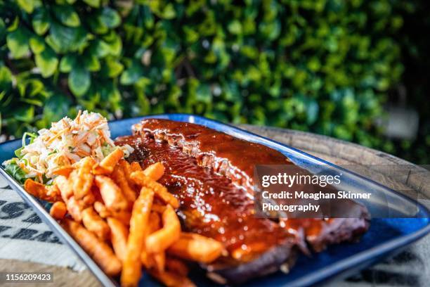 bourbon bbq pork ribs with sweet potato fries & slaw - sweet potato fries stock pictures, royalty-free photos & images