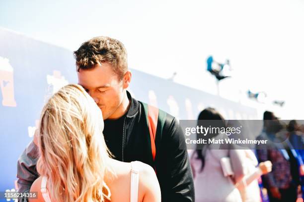 Cassie Randolph and Colton Underwood attend the 2019 MTV Movie and TV Awards at Barker Hangar on June 15, 2019 in Santa Monica, California.