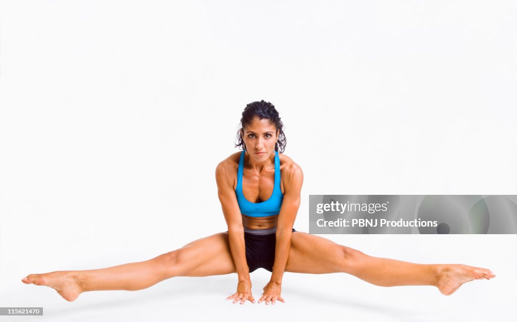 Mixed race woman gymnast balancing on hands