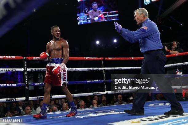 Referee Jay Nady gives a count to Sullivan Barrera after he was knocked down in the eighth round by Jesse Hart during a light heavyweight fight at...