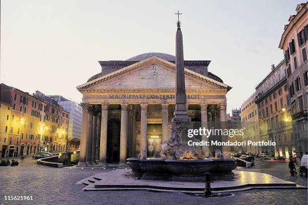 Italy; Lazio; Rome; Piazza della Rotonda. View Pantheon front fountain square lights evening columns tympanum facade Roman monument