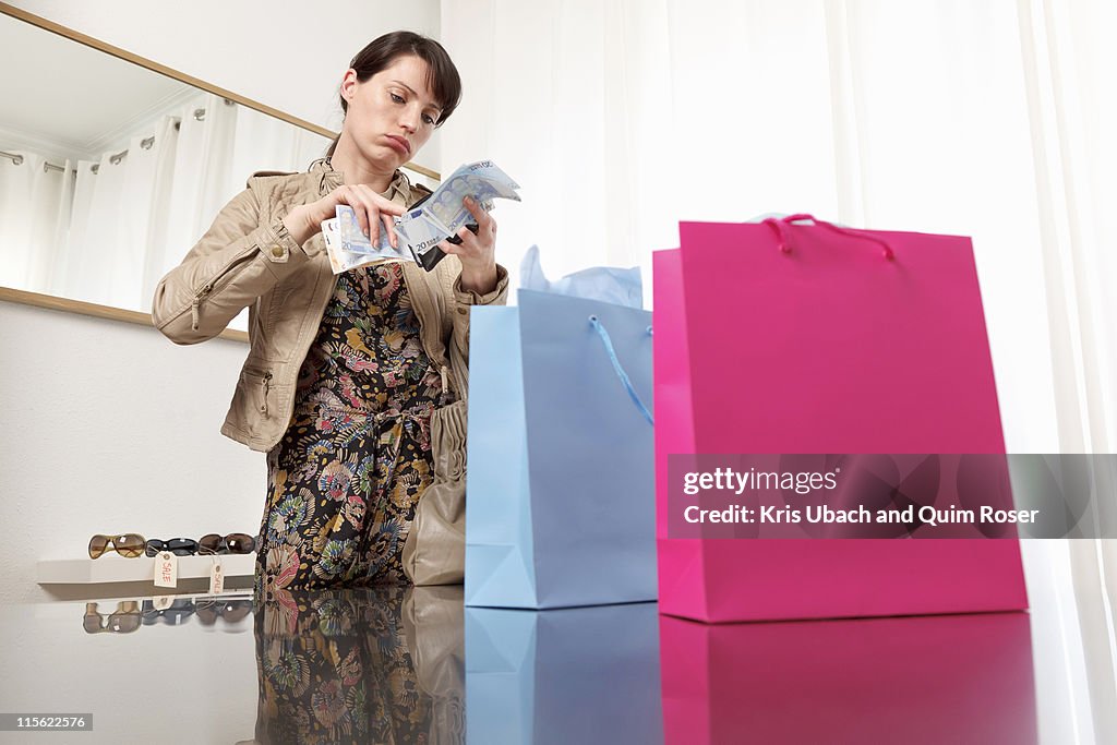 Woman checking money from purse