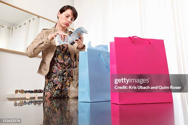woman checking money from purse - change purse stock pictures, royalty-free photos & images