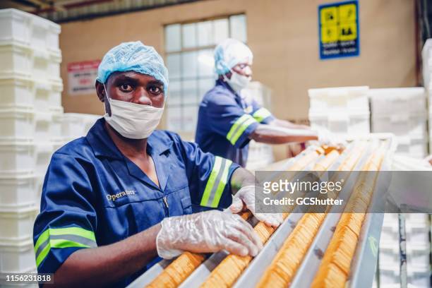 portrait of a production line worker in africa - minimum wage stock pictures, royalty-free photos & images