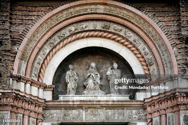 Italy; Emilia Romagna; Bologna; San Petronio Basilica. Detail. Lunette main doorway facade Madonna/Virgin Mary with Child Enthroned clothes fabric on...