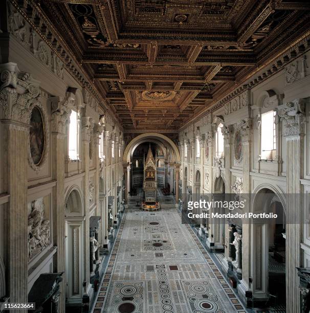 Italy, Lazio, Rome, San Giovanni in Laterano Basilica, St John Lateran. Detail. View of interior nave Cosmatesque floor rounded arches pilaster...