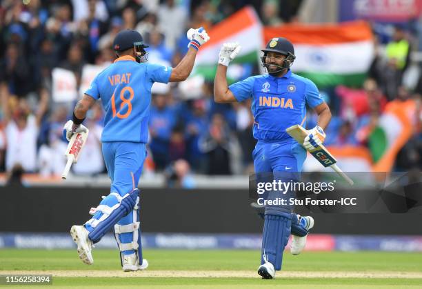 Rohit Sharma of India reaches his century and is congratulated by Virat Kohli of India during the Group Stage match of the ICC Cricket World Cup 2019...