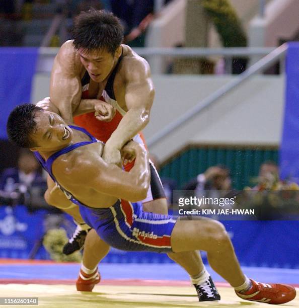 Japanese Shingo Matsumoto in action with South Korean Kim Jung-Sub during the Men's Greco Roman Style 84kg final match for the 14th Asian Games Busan...
